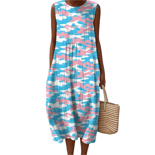 Person wearing a blue and pink camouflage dress on a beach.
